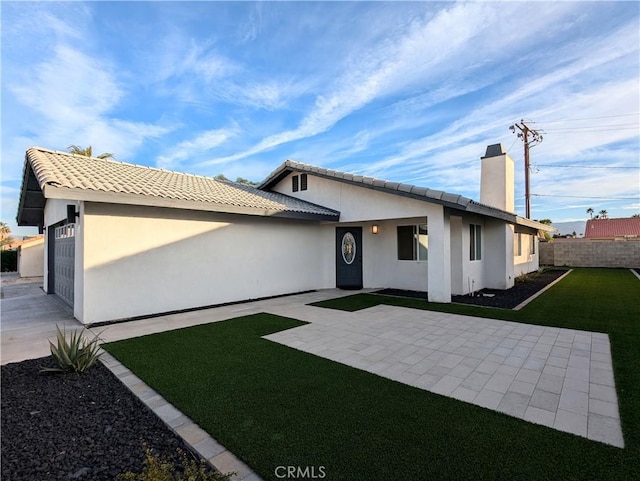 67685 Verona Rd, Cathedral City, CA 92234 - view of front of home with a front yard, a chimney, fence, a patio, and stucco siding