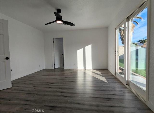 67685 Verona Rd, Cathedral City, CA 92234 - empty room featuring a healthy amount of sunlight, baseboards, and dark wood-style floors