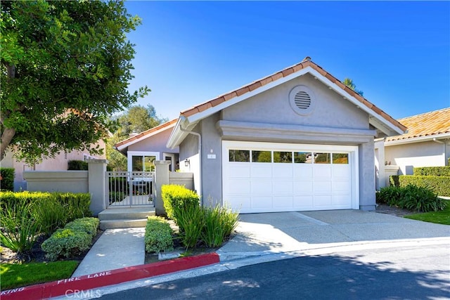 4 Malaquita, Coto De Caza, CA 92679 - view of front of house with a tile roof, stucco siding, driveway, a gate, and a garage