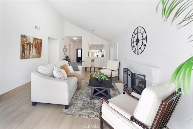4 Malaquita, Coto De Caza, CA 92679 - living room with high vaulted ceiling, baseboards, visible vents, a fireplace, and wood finished floors