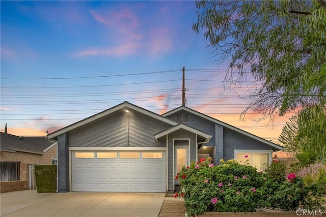 7524 Matterhorn Ave, Rancho Cucamonga, CA 91730 - mid-century modern home featuring concrete driveway, stucco siding, and an attached garage