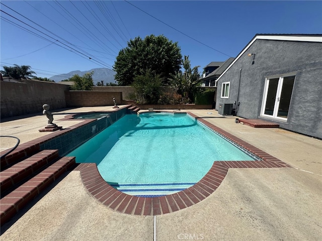 7524 Matterhorn Ave, Rancho Cucamonga, CA 91730 - view of pool with a pool with connected hot tub, a fenced backyard, a patio area, a mountain view, and french doors