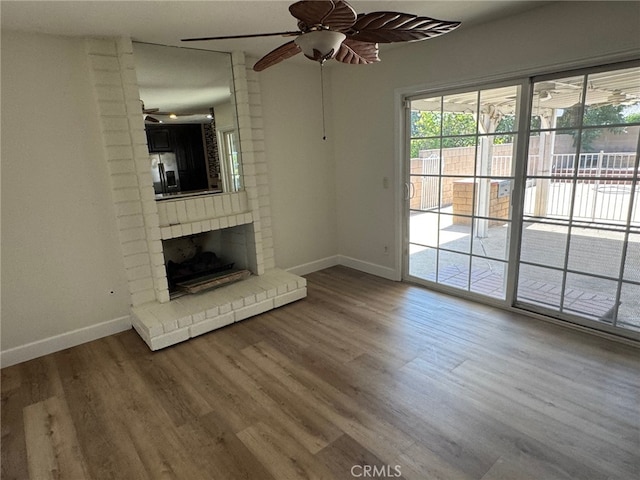 7524 Matterhorn Ave, Rancho Cucamonga, CA 91730 - unfurnished living room with a ceiling fan, wood finished floors, and a brick fireplace