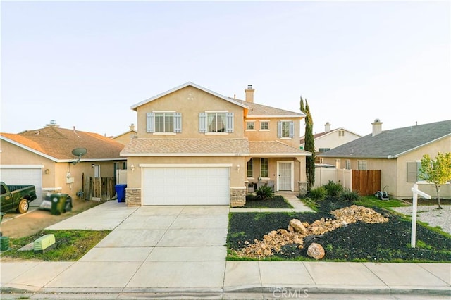 view of front of house with stucco siding, stone siding, fence, concrete driveway, and an attached garage