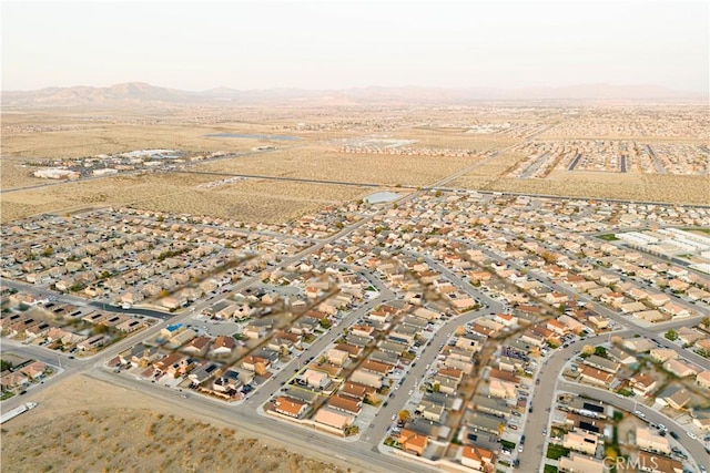drone / aerial view with view of desert and a mountain view
