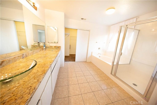 full bathroom with visible vents, a sink, a shower stall, tile patterned flooring, and a bath