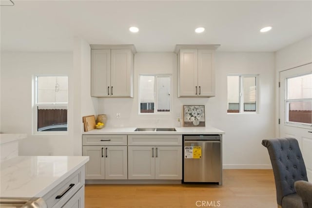 kitchen with recessed lighting, stainless steel dishwasher, light wood-style flooring, and light countertops