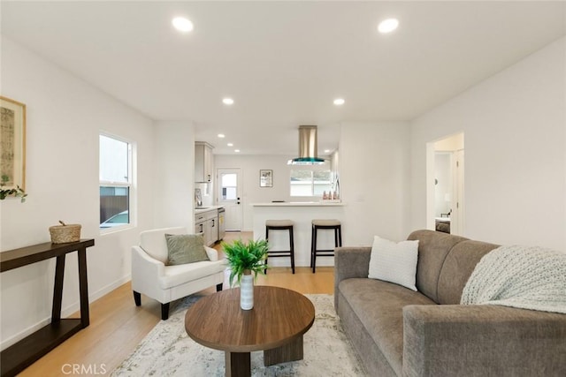 living area with recessed lighting and light wood-style floors