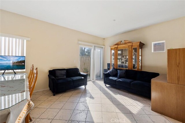 living area featuring baseboards