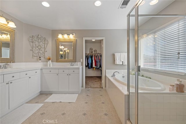 bathroom with a bath, vanity, tile patterned flooring, visible vents, and recessed lighting
