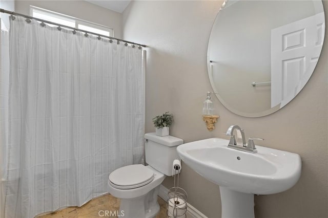 bathroom with tile patterned flooring, a sink, a shower with curtain, and toilet