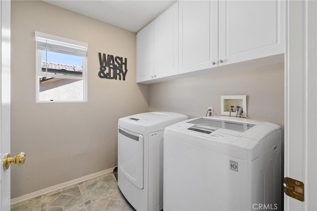washroom featuring cabinet space, washing machine and clothes dryer, and baseboards