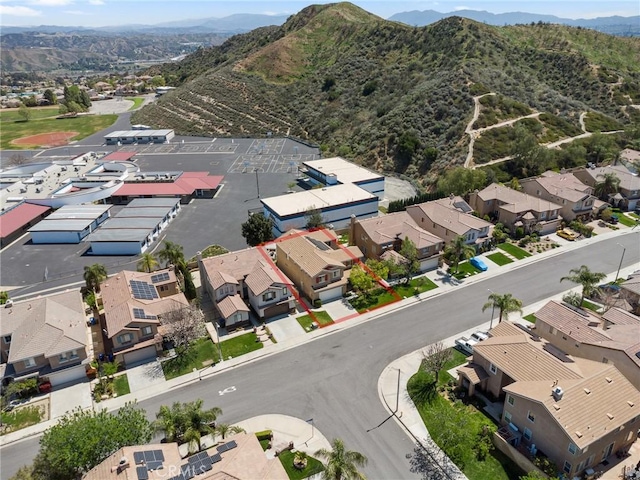 birds eye view of property with a mountain view and a residential view