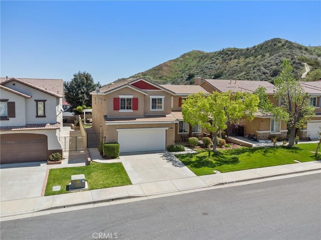 traditional-style home with a garage, stucco siding, a tile roof, a mountain view, and concrete driveway