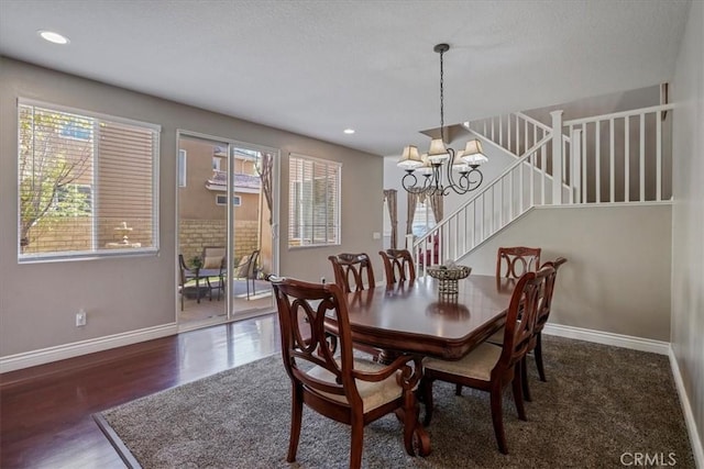dining space featuring baseboards, an inviting chandelier, recessed lighting, stairs, and wood finished floors