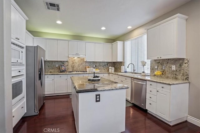 kitchen featuring a sink, dark wood finished floors, a kitchen island, and stainless steel appliances