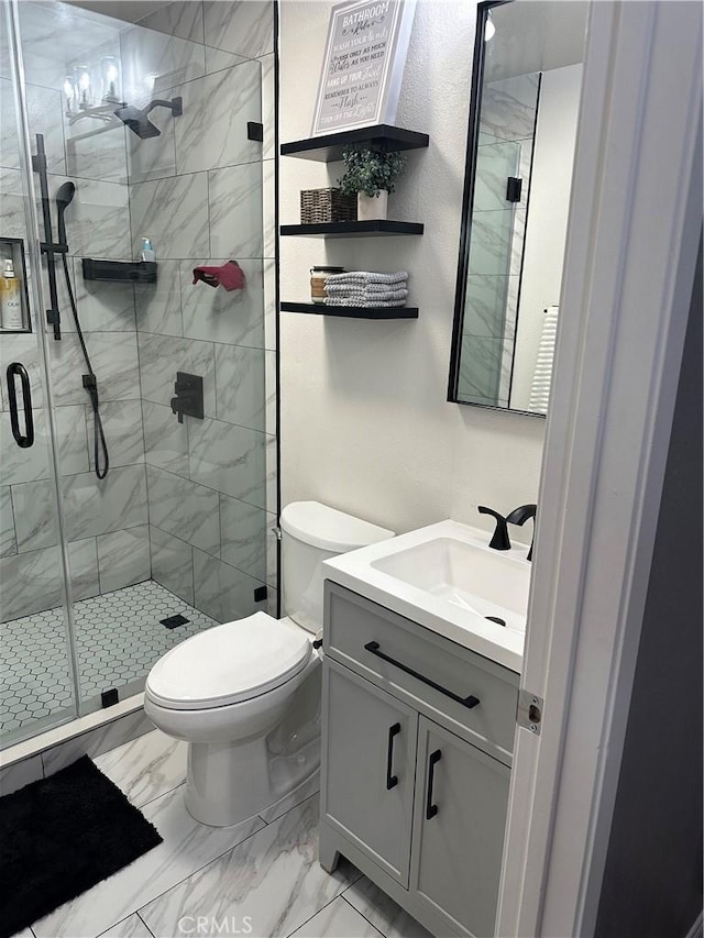 full bath with marble finish floor, toilet, vanity, and a shower stall