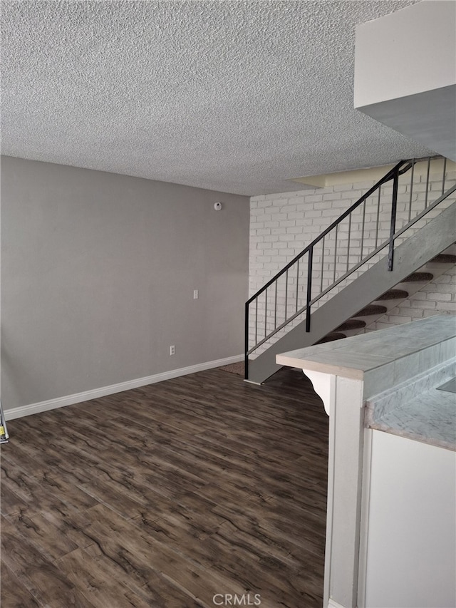 3408 20th St, Highland, CA 92346 - staircase featuring a textured ceiling, wood finished floors, and baseboards