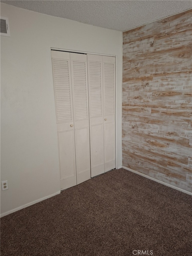 3408 20th St, Highland, CA 92346 - unfurnished bedroom featuring carpet floors, a closet, and a textured ceiling
