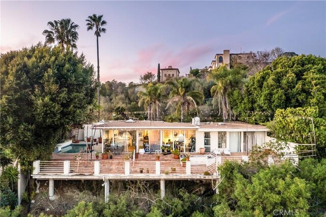 back of property with an outdoor pool