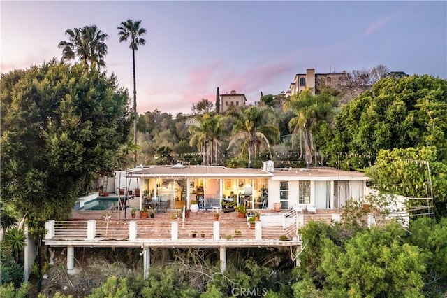 1223 Skyline Dr, Laguna Beach, CA 92651 - back of house at dusk with a patio area and an outdoor pool