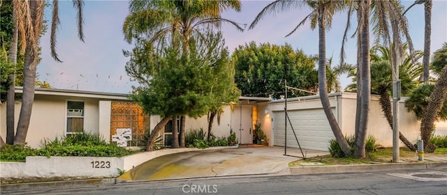 1223 Skyline Dr, Laguna Beach, CA 92651 - view of front of house featuring stucco siding, concrete driveway, and an attached garage