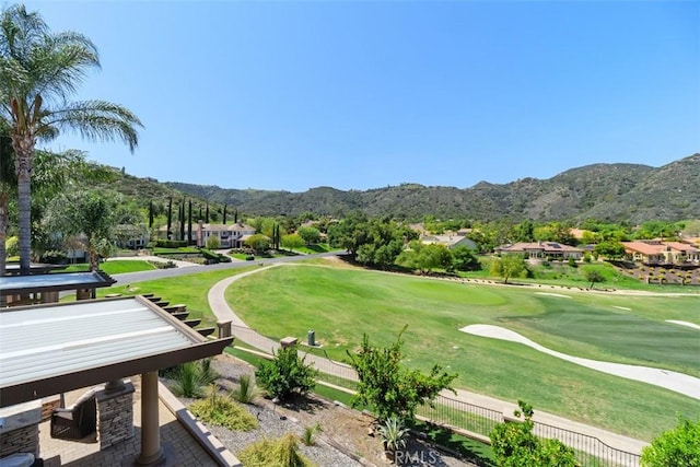view of home's community featuring golf course view, a mountain view, a residential view, and a lawn