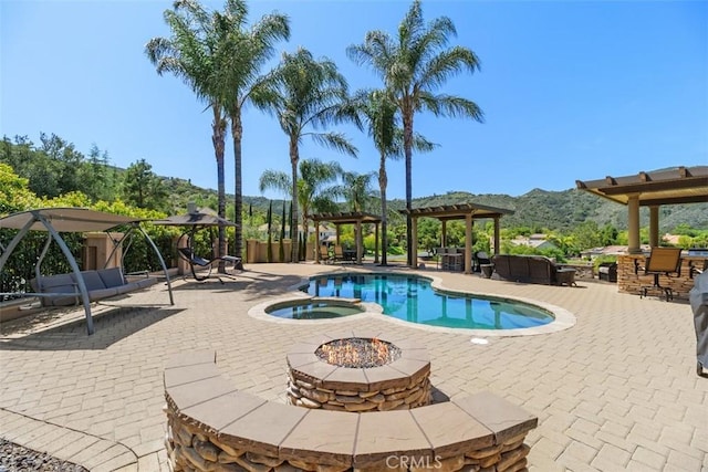 view of swimming pool with a patio, a mountain view, a pergola, a pool with connected hot tub, and a gazebo