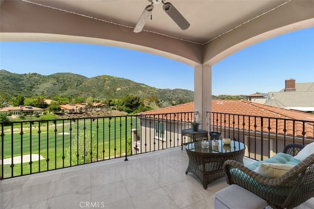 balcony with a mountain view and ceiling fan