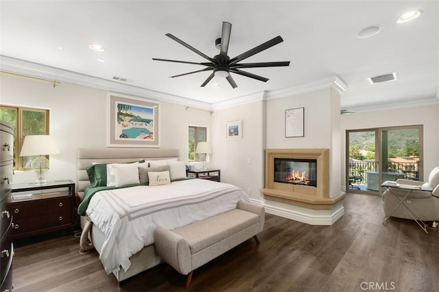 bedroom featuring a glass covered fireplace, access to outside, ornamental molding, visible vents, and wood finished floors