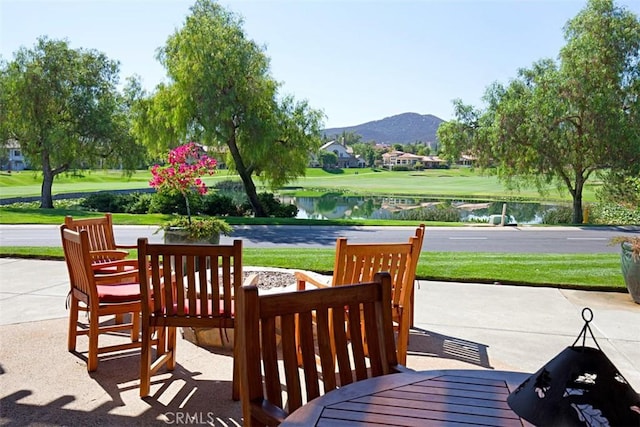 view of patio / terrace with a water and mountain view