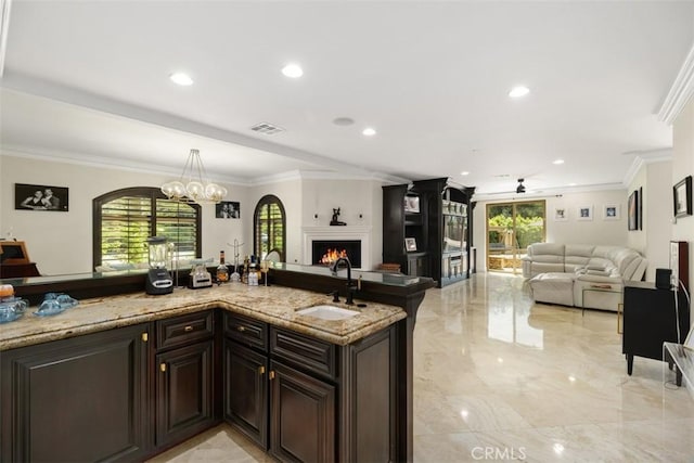 kitchen with a wealth of natural light, open floor plan, visible vents, and marble finish floor
