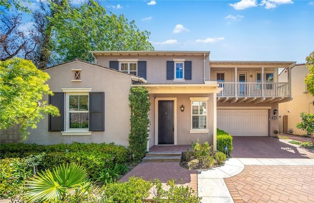 37 Fanpalm, Irvine, CA 92620 - view of front of house featuring stucco siding, a balcony, a garage, and decorative driveway