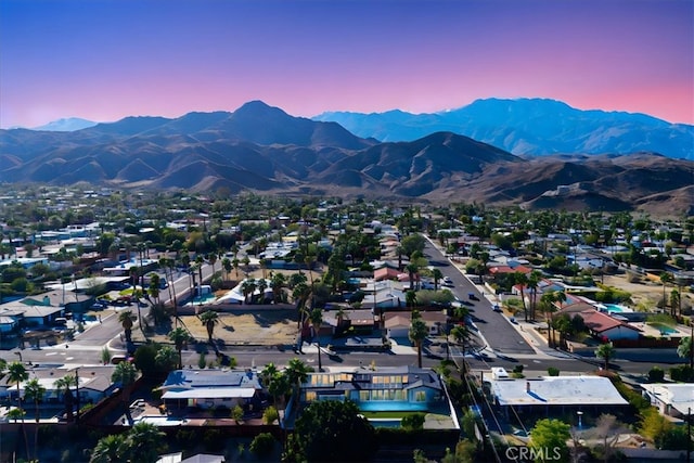 aerial view at dusk with a mountain view and a residential view
