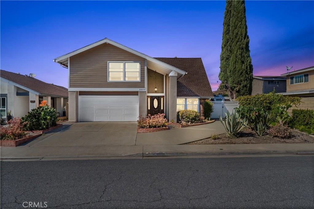 5377 Andrew Dr, La Palma, CA 90623 - view of front facade with fence, driveway, a gate, and an attached garage