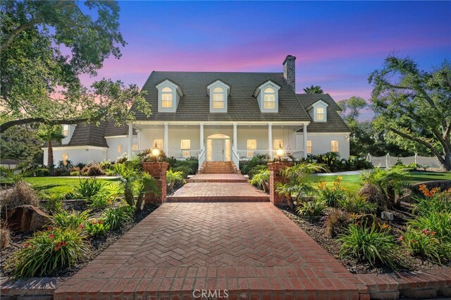 45325 Via Vaquero, Temecula, CA 92590 - cape cod-style house with a chimney, a porch, and fence