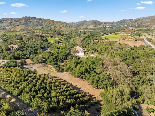 birds eye view of property with a view of trees and a mountain view
