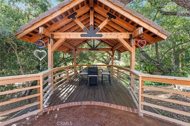 deck with a gazebo and outdoor dining space