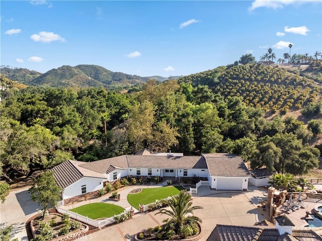 drone / aerial view with a forest view and a mountain view