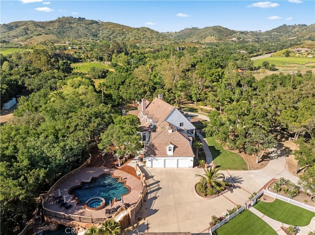 45325 Via Vaquero, Temecula, CA 92590 - aerial view of property's location with a mountain backdrop, a heavily wooded area, and a pool area
