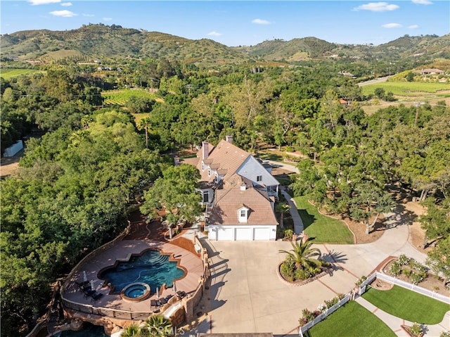 drone / aerial view featuring a view of trees and a mountain view