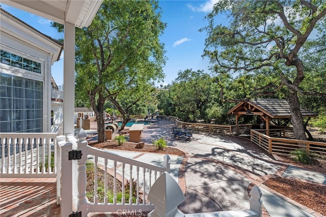 view of patio / terrace with a gazebo and an outdoor pool
