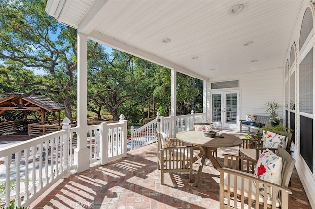 view of patio / terrace with french doors, a gazebo, and outdoor dining space