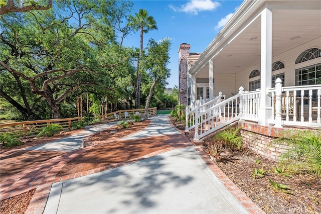 view of side of home featuring driveway and a chimney