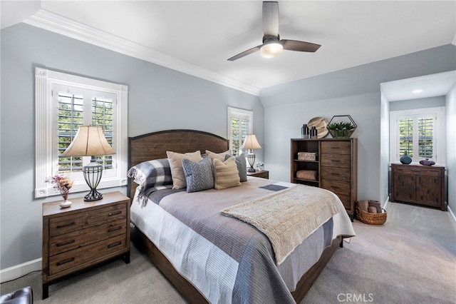 bedroom with light carpet, a ceiling fan, baseboards, and crown molding
