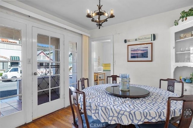 308 Catalina Ave, Avalon, CA 90704 - dining room featuring a notable chandelier, wood finished floors, and a wealth of natural light
