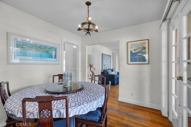 308 Catalina Ave, Avalon, CA 90704 - dining area featuring an inviting chandelier, wood finished floors, and baseboards