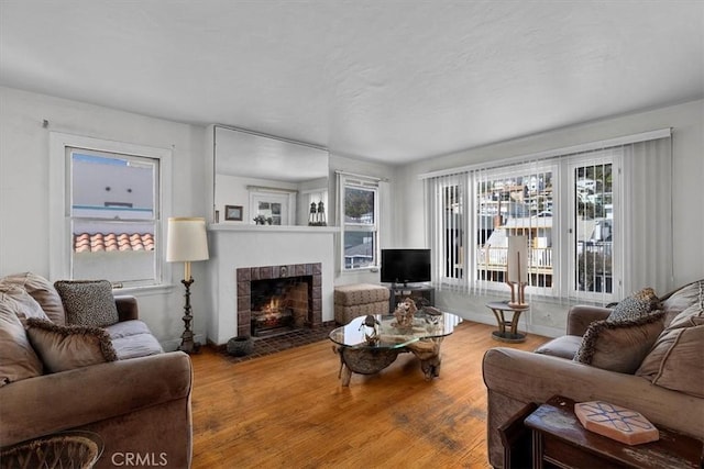 308 Catalina Ave, Avalon, CA 90704 - living area featuring a brick fireplace and wood finished floors