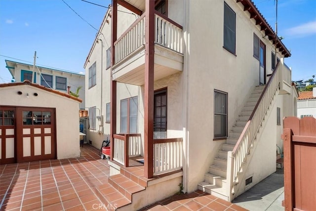 308 Catalina Ave, Avalon, CA 90704 - view of home's exterior with stucco siding, an outdoor structure, and stairway