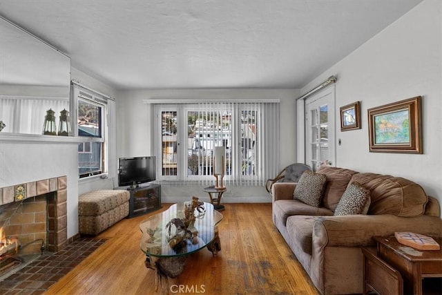 308 Catalina Ave, Avalon, CA 90704 - living area featuring a textured ceiling, a tiled fireplace, and hardwood / wood-style flooring